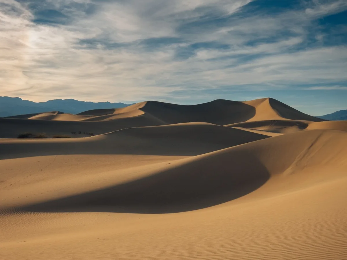 Mesquite Flat Sand Dunes shaped by low side light with strong alternating bands of sun and shadow