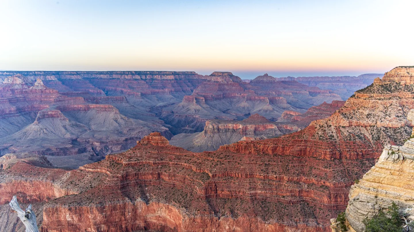 Layered Grand Canyon formations viewed from the South Rim in soft sunrise light
