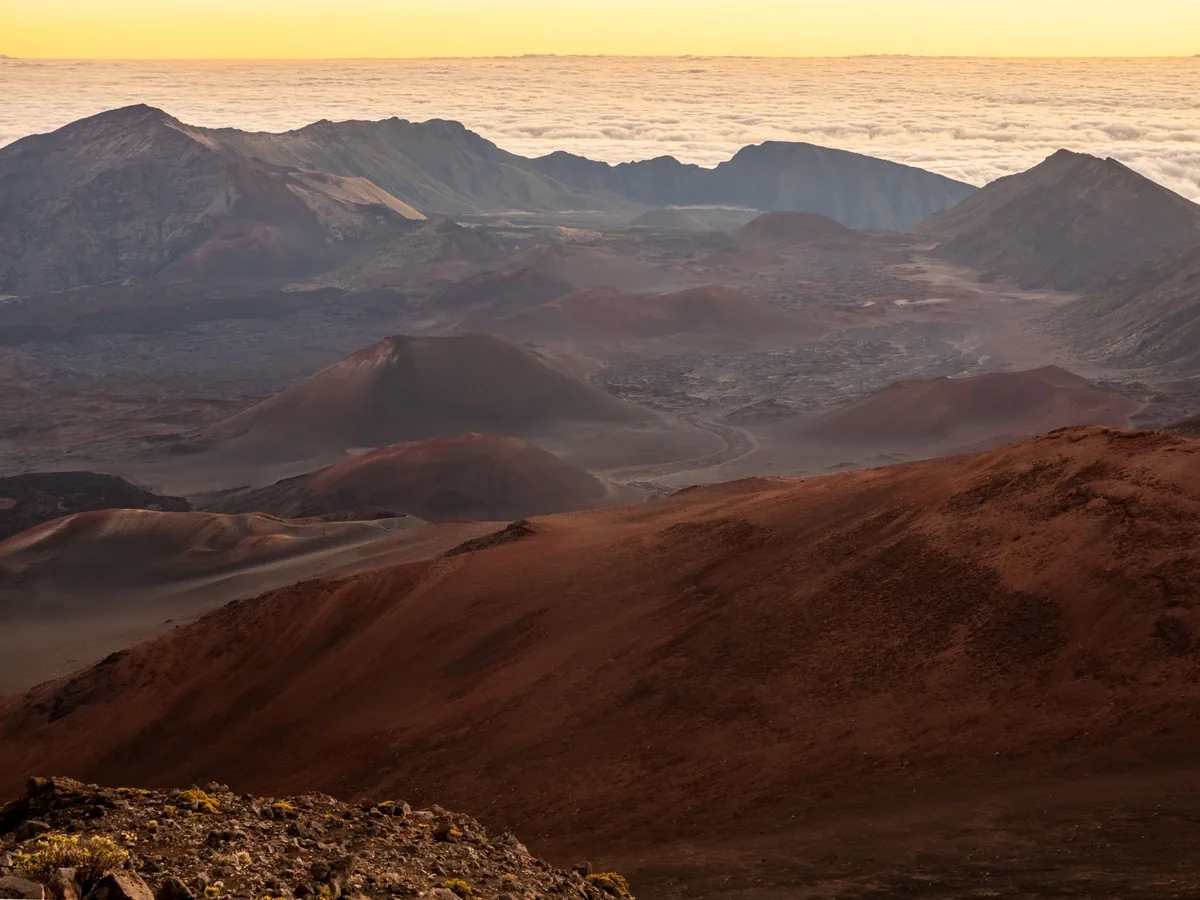 Haleakalā crater cinder cones and volcanic ridges beneath a cloud deck