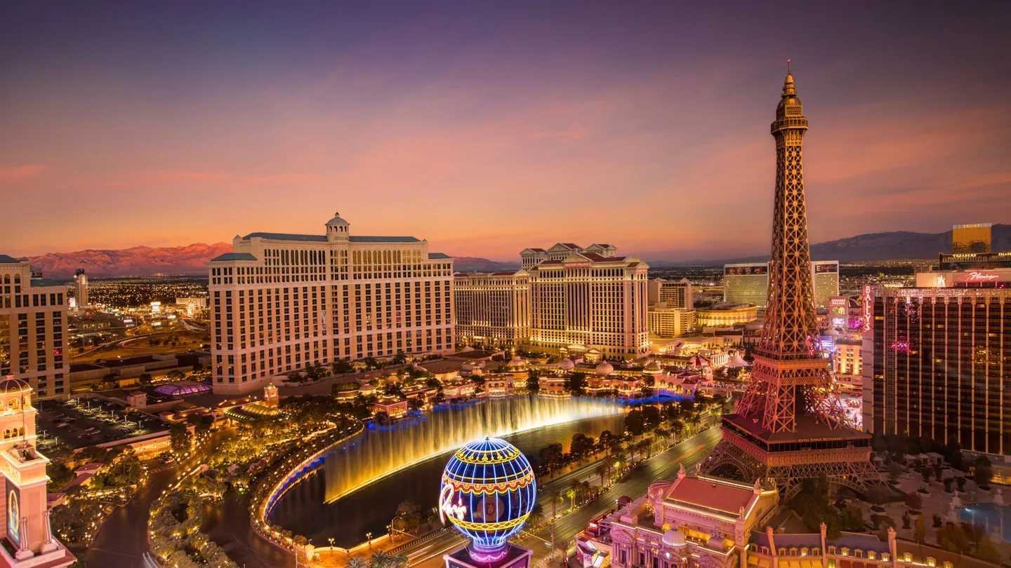 Bellagio, Paris Las Vegas and the central Las Vegas Strip illuminated beneath a colorful dusk sky