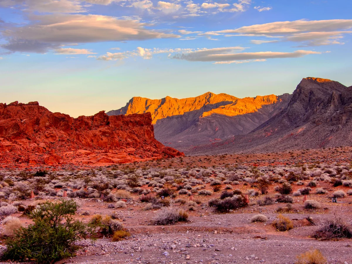 Red Rock Canyon desert terrain and mountains illuminated by warm low-angle sunlight