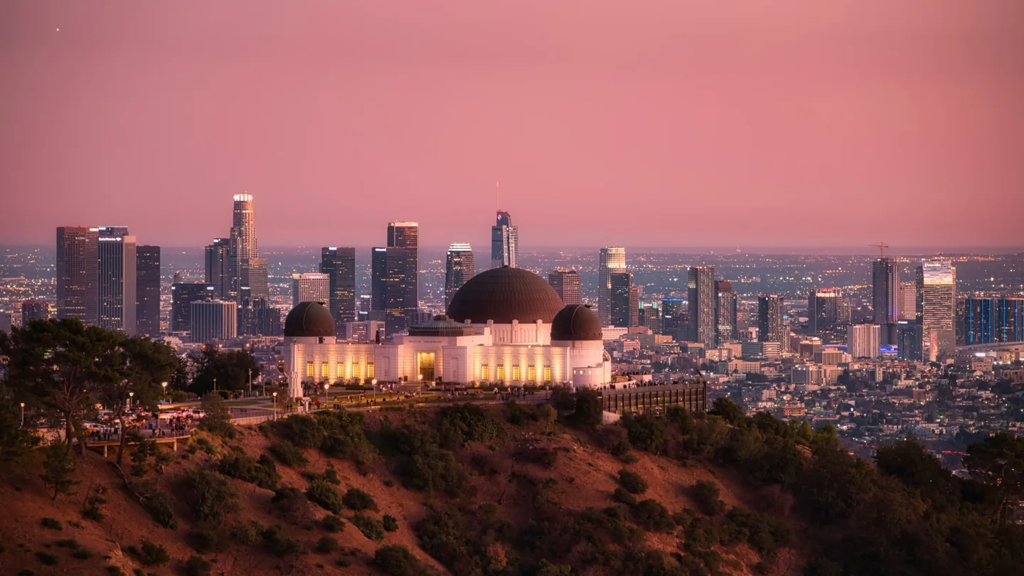 Griffith Observatory overlooking Downtown Los Angeles beneath a pink evening sky