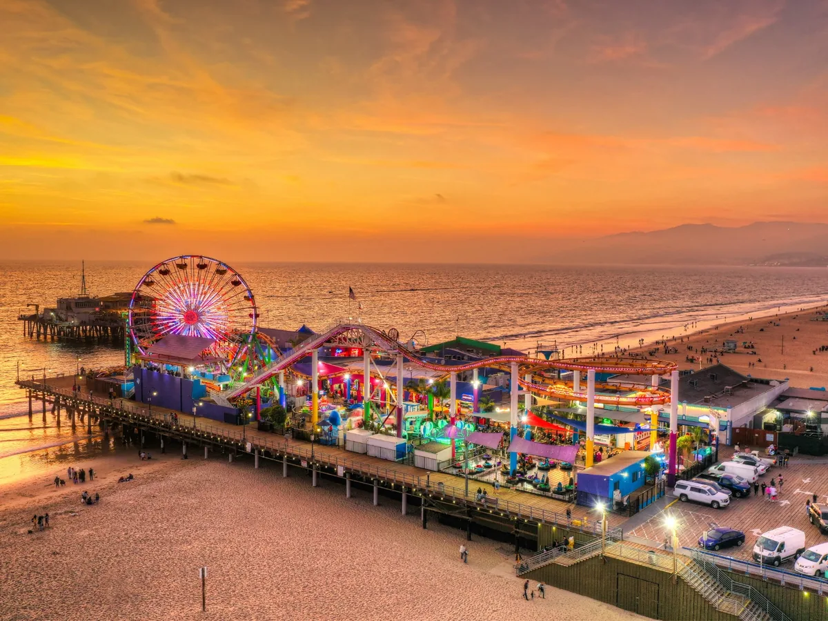 Santa Monica Pier and Pacific Park glowing during a colorful Los Angeles sunset
