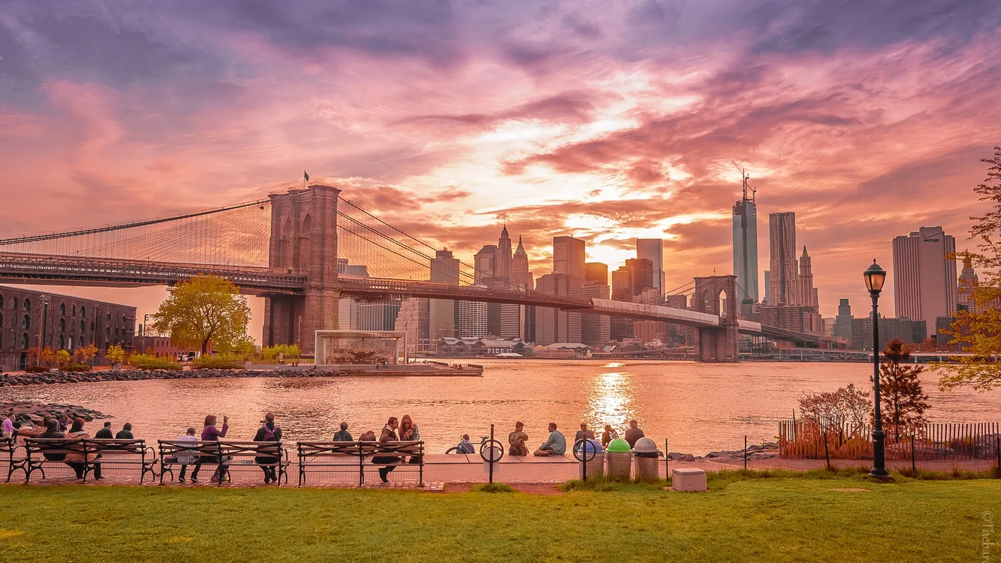 Brooklyn Bridge and Lower Manhattan skyline during a colorful sunset from Brooklyn Bridge Park