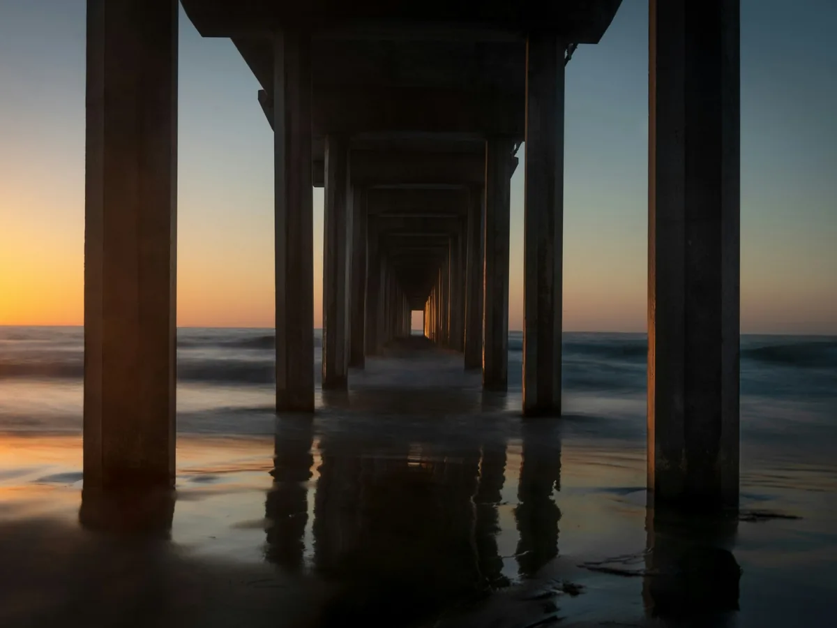 Sunset beside the repeating pilings of Scripps Pier in La Jolla