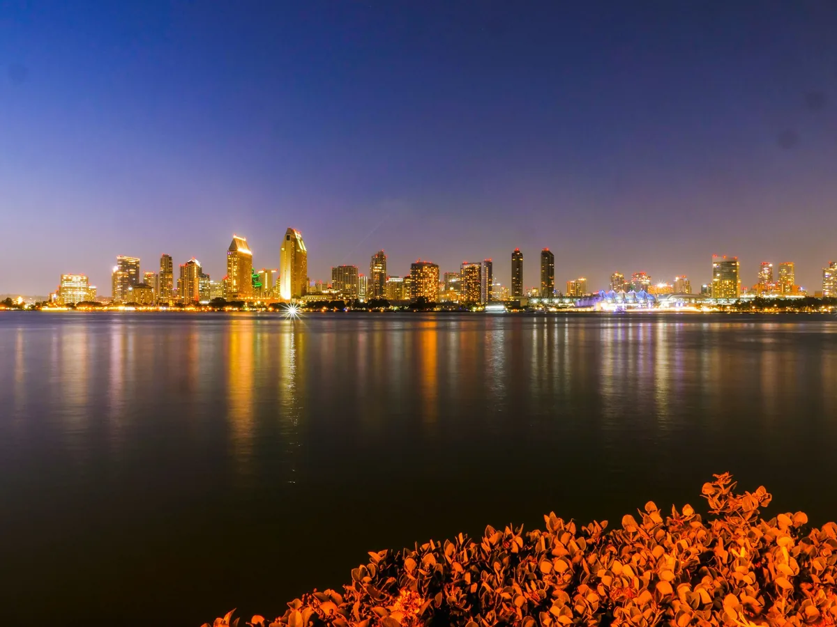 San Diego skyline illuminated across the bay from Coronado during twilight