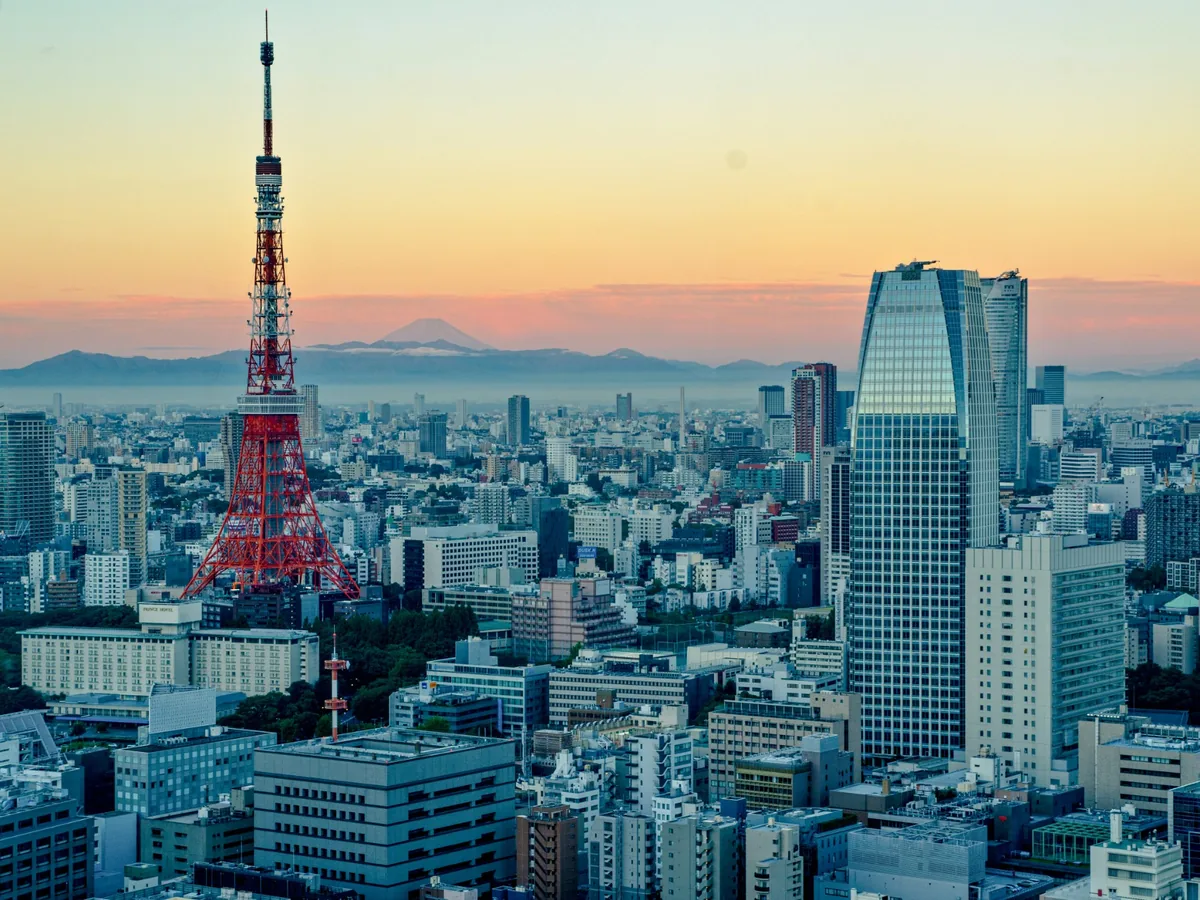 Tokyo Tower rising above the city skyline in fading warm evening light